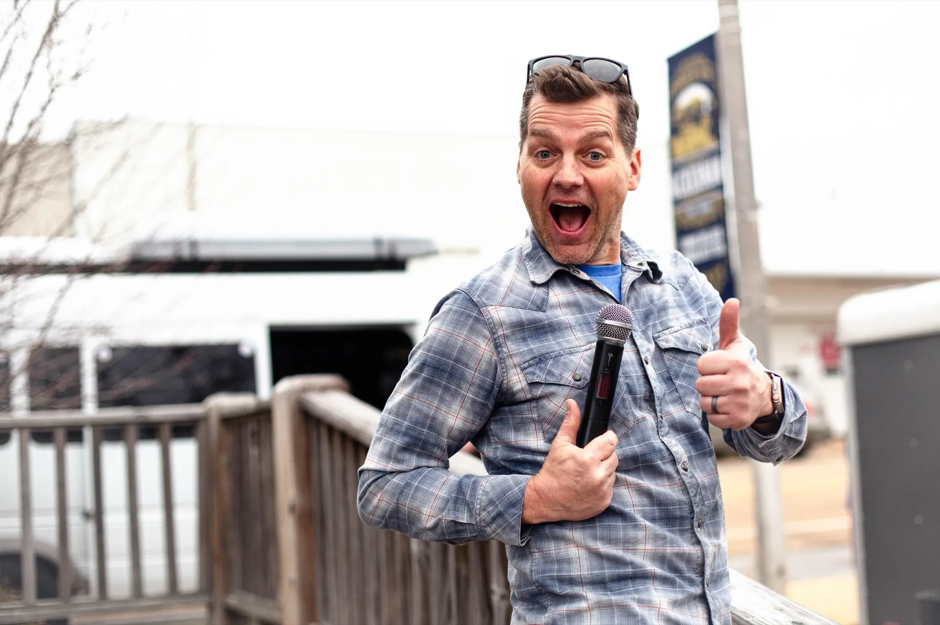 Jason Shearer with microphone at an outdoor event